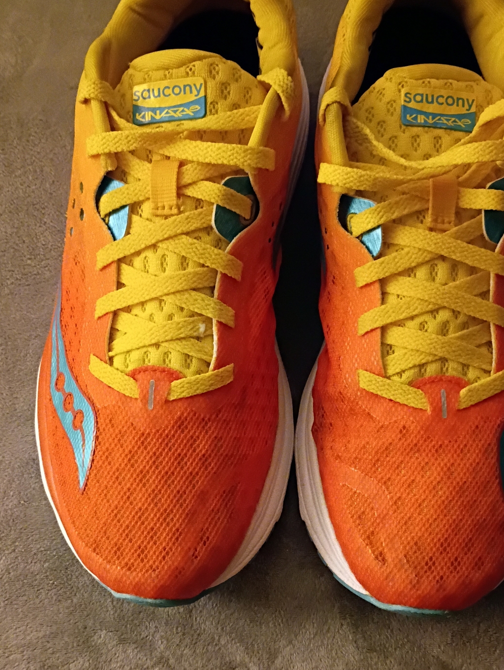 Saucony Woman Kinvara Sneakers in Orange and Yellow with Teal Accent
